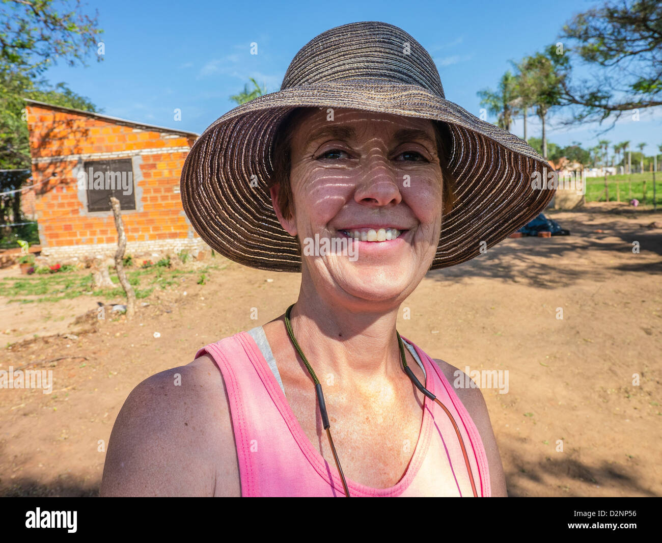 A female American volunteer for a Habitat for Humanity build in Paraguay on the work site in Luque, Paraguay. Stock Photo