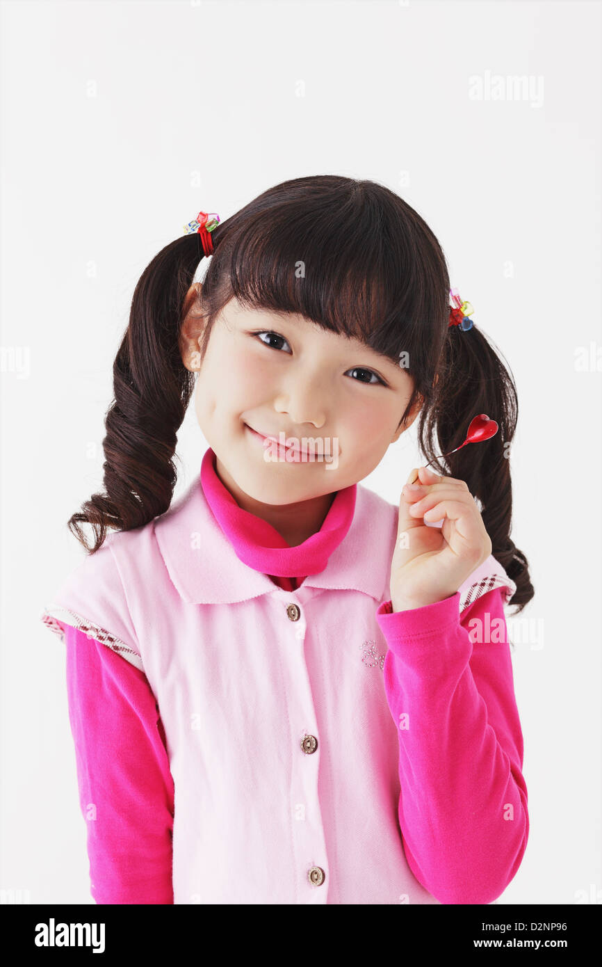 Young girl smiling at camera Stock Photo - Alamy