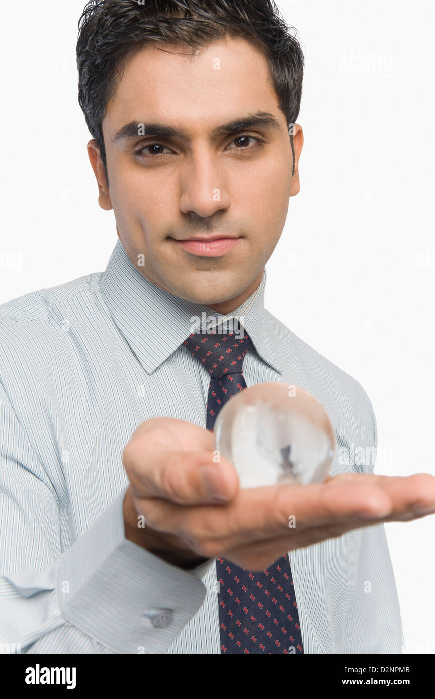 Portrait of a businessman holding a crystal ball Stock Photo - Alamy