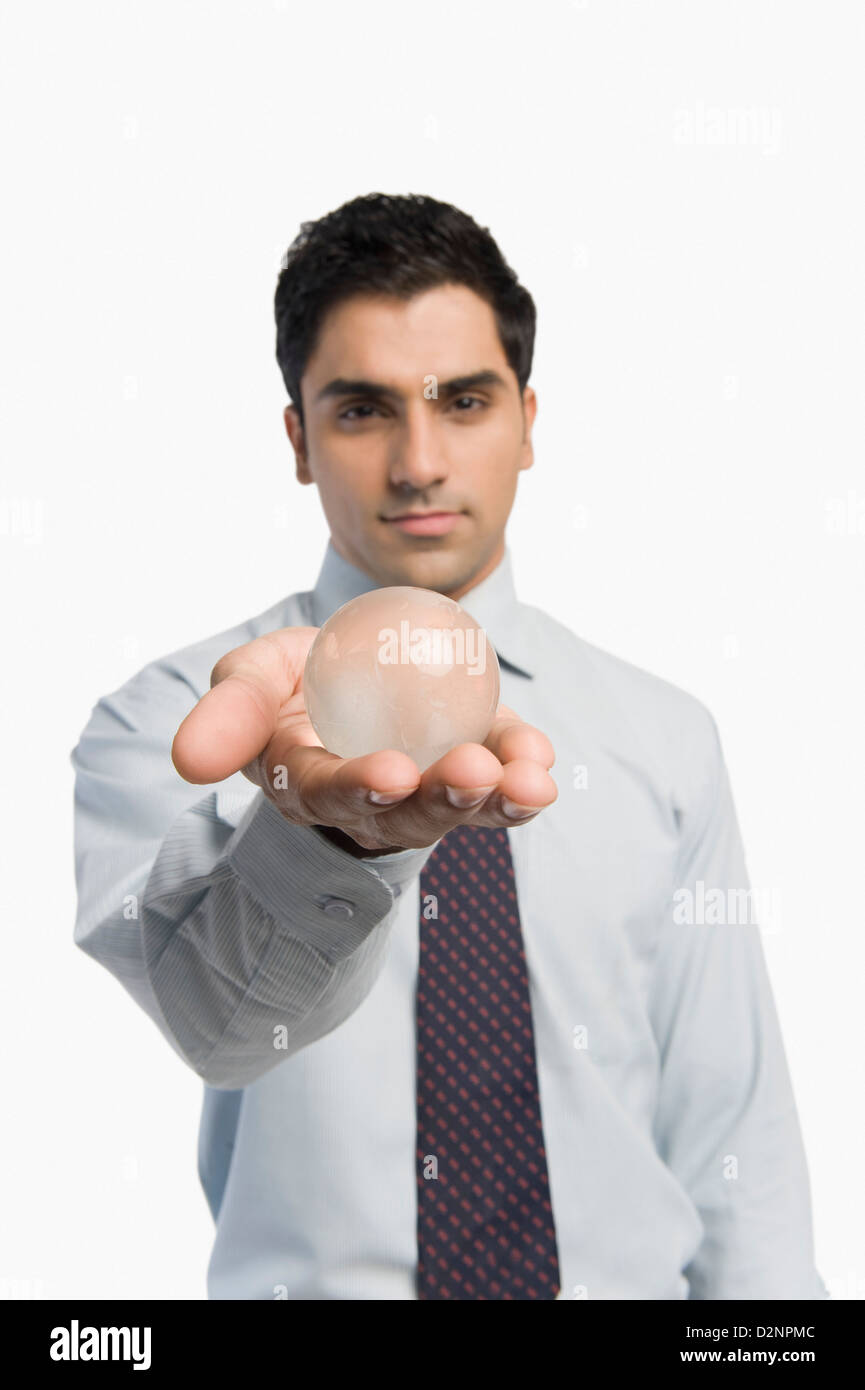 Portrait of a businessman holding a crystal ball Stock Photo - Alamy