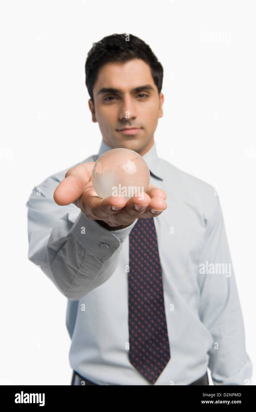 Portrait of a businessman holding a crystal ball Stock Photo - Alamy