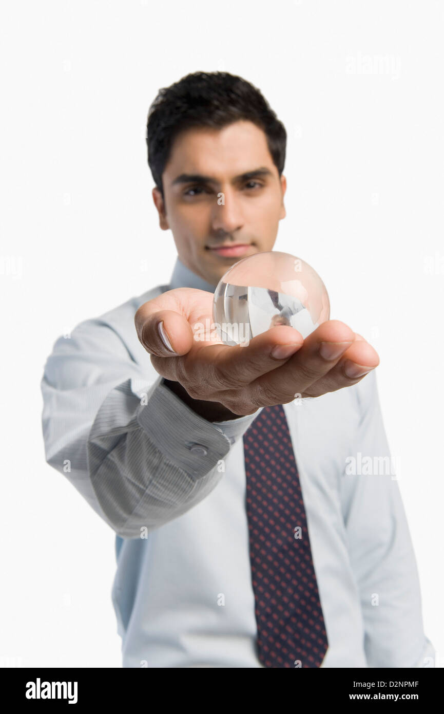 Portrait of a businessman holding a crystal ball Stock Photo - Alamy