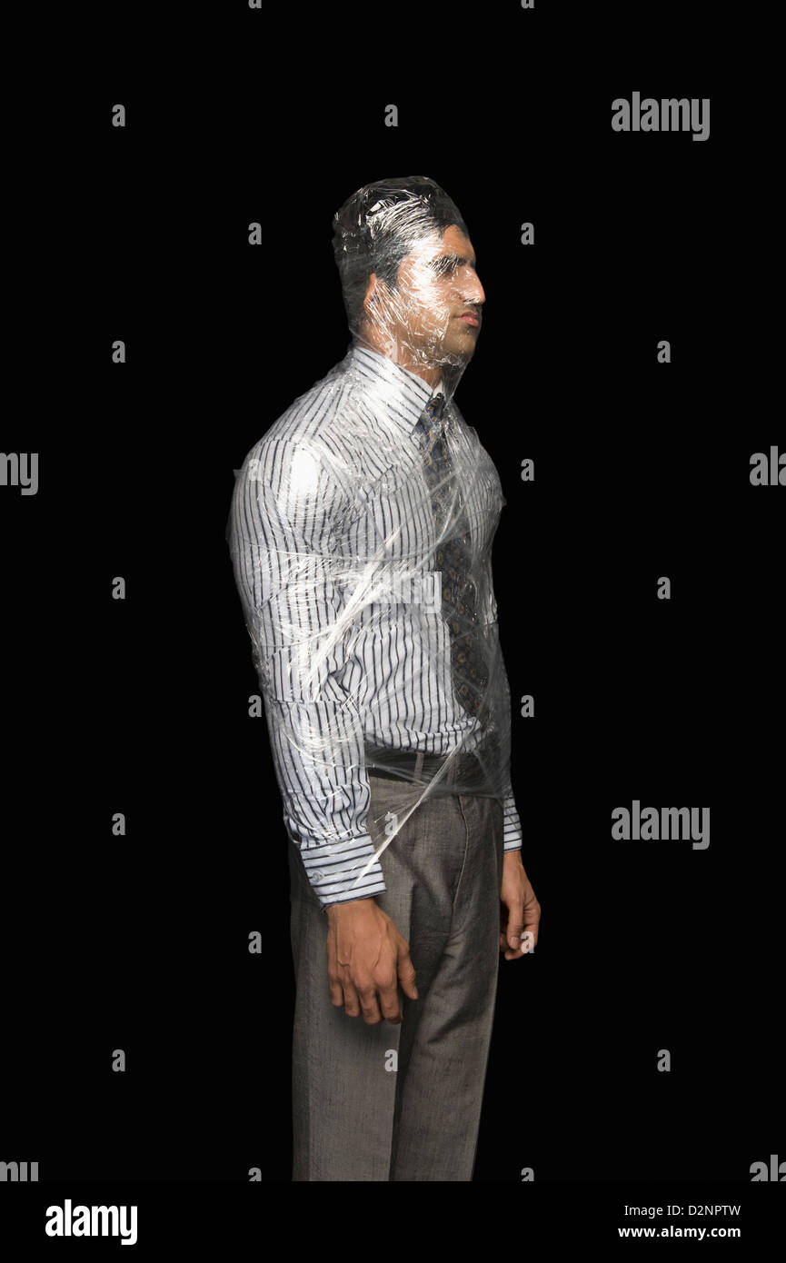 Businessman wrapped in a plastic wrap Stock Photo - Alamy