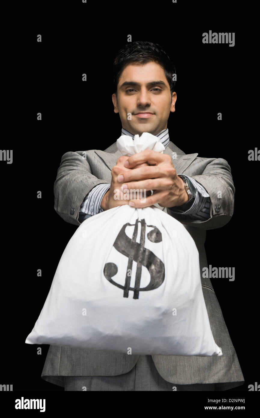 Businessman showing a money bag Stock Photo Alamy