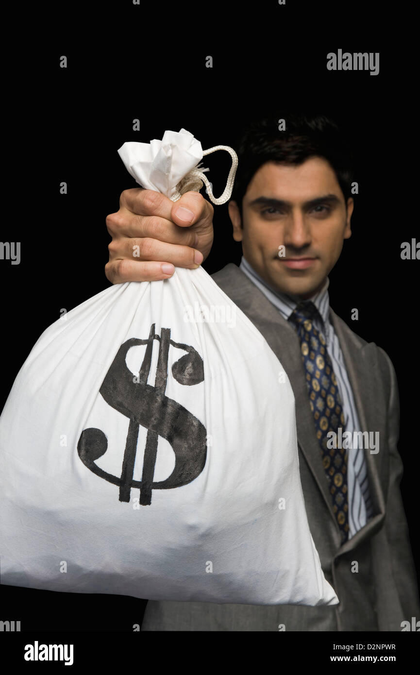 Businessman showing a money bag Stock Photo Alamy