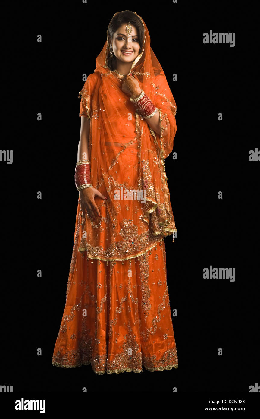 Bride smiling in traditional wedding dress Stock Photo - Alamy