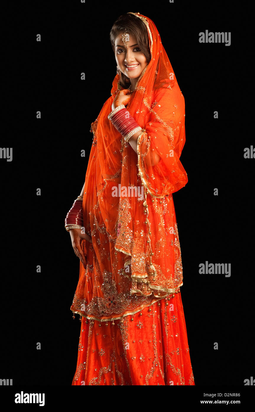 Bride smiling in traditional wedding dress Stock Photo - Alamy