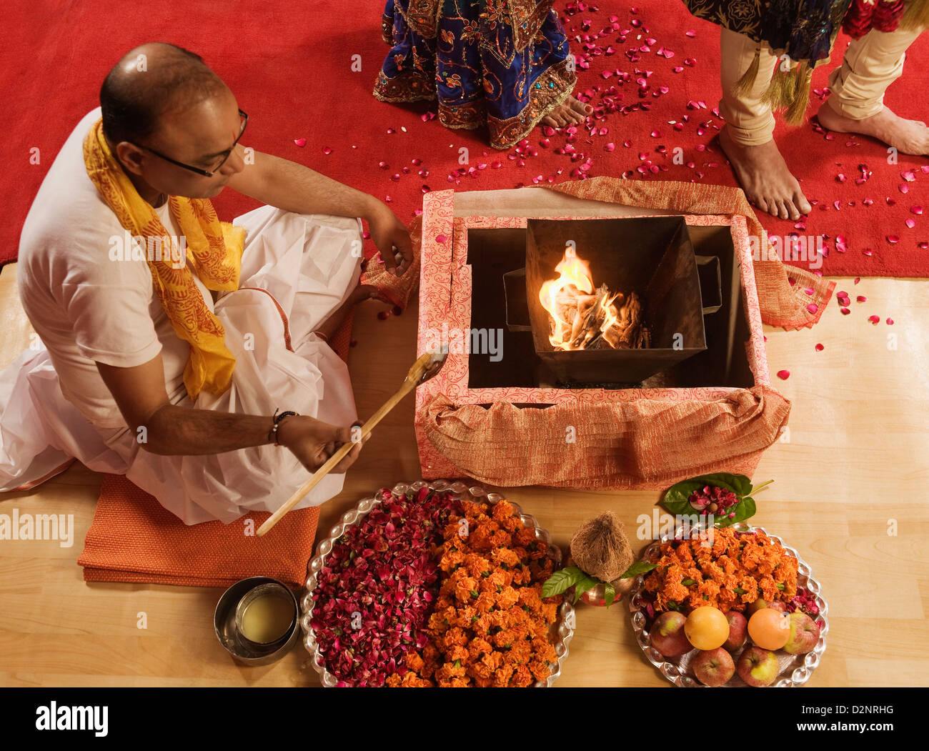 Priest performing religious ceremony in wedding mandap Stock Photo