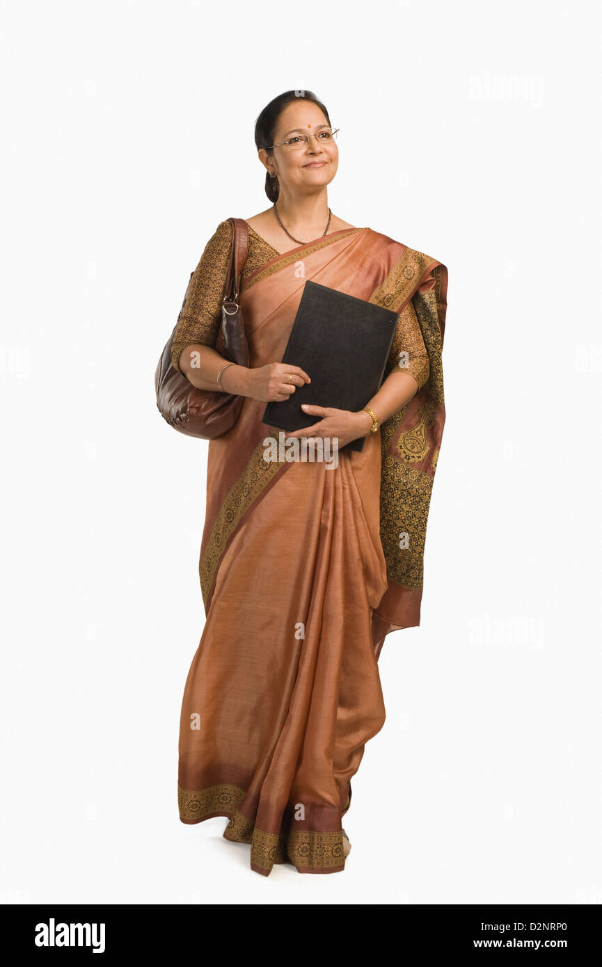 Indian woman walking in sari Cut Out Stock Images & Pictures - Alamy