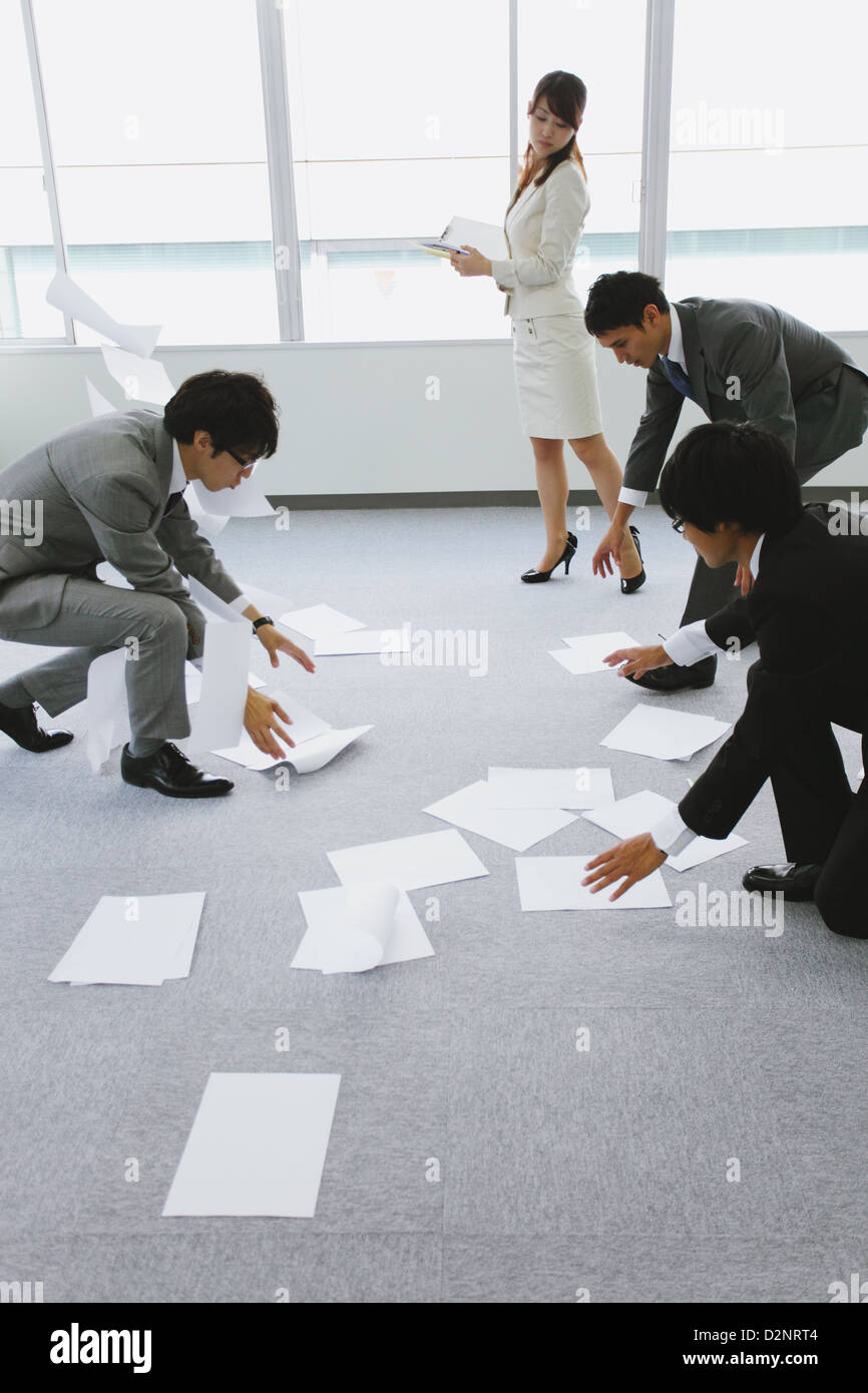 Business people picking up papers Stock Photo Alamy