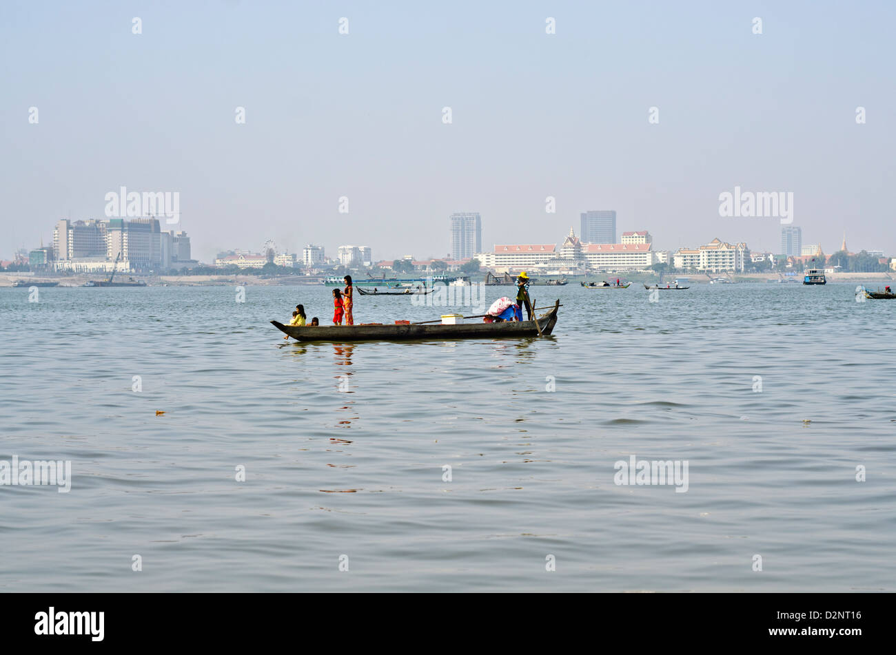 Fisherman boat on the Mekong river in Phnom Penh , 500 meters from some of the most expensive city hotels. Stock Photo