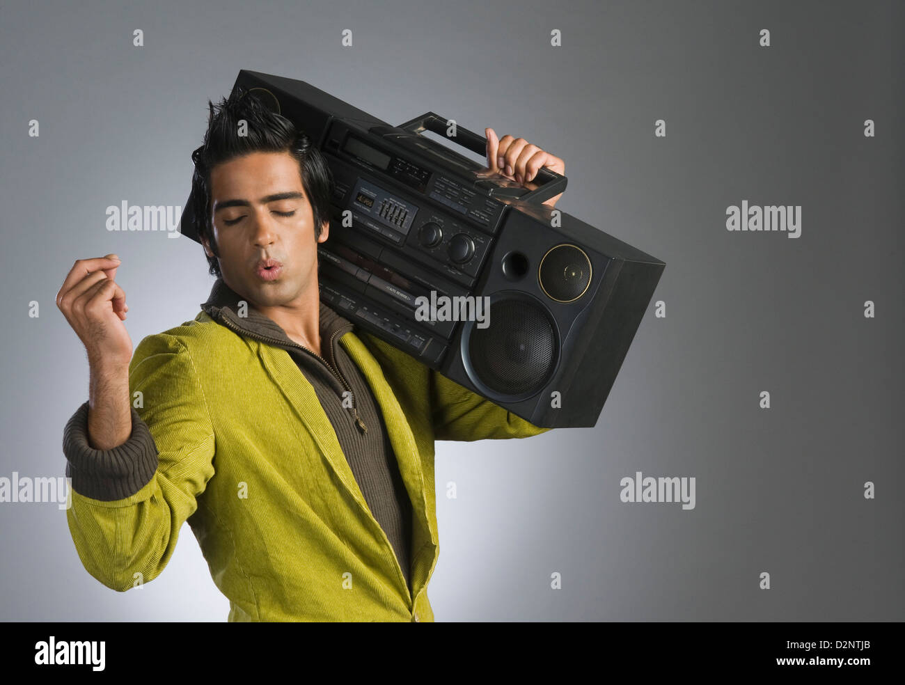 Man listening to a music system and whistling Stock Photo Alamy