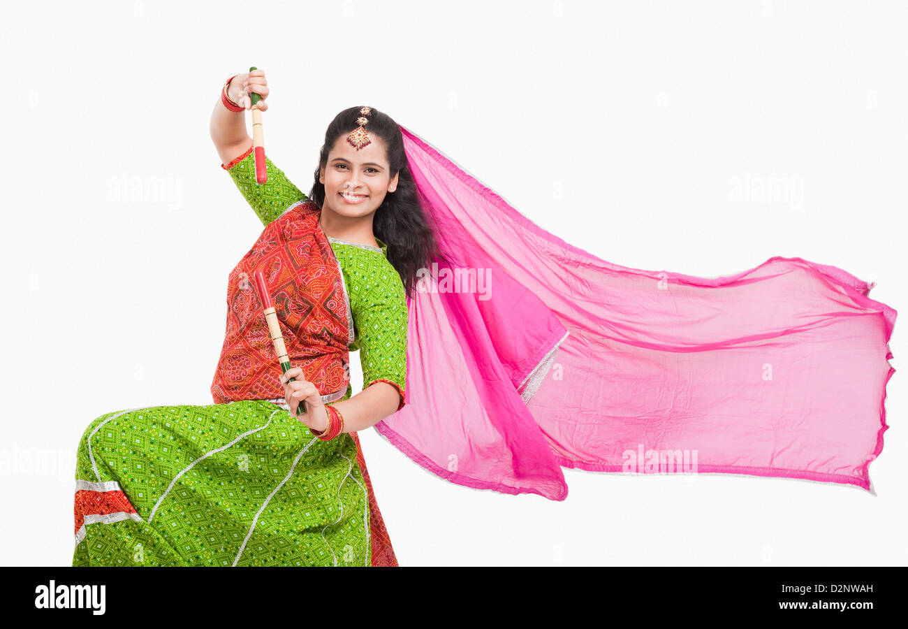 Woman performing dandiya Stock Photo - Alamy