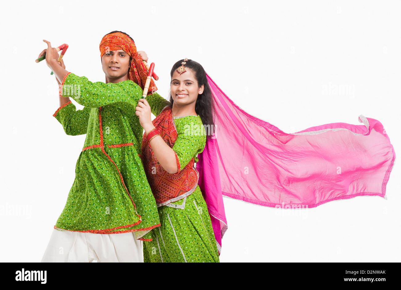 Couple performing dandiya Stock Photo - Alamy
