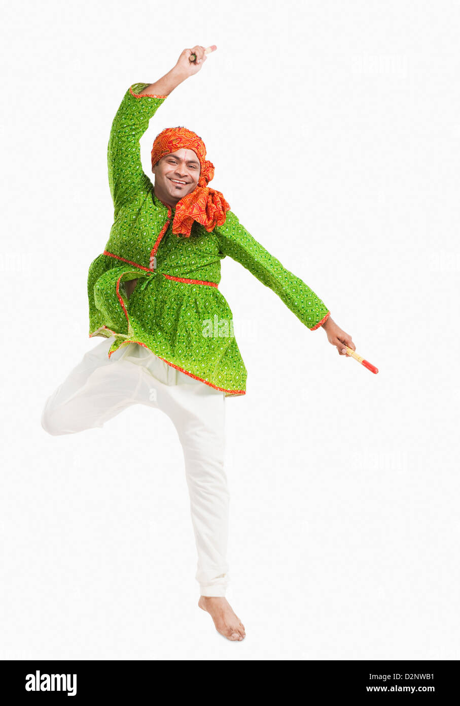 Man performing dandiya Stock Photo - Alamy