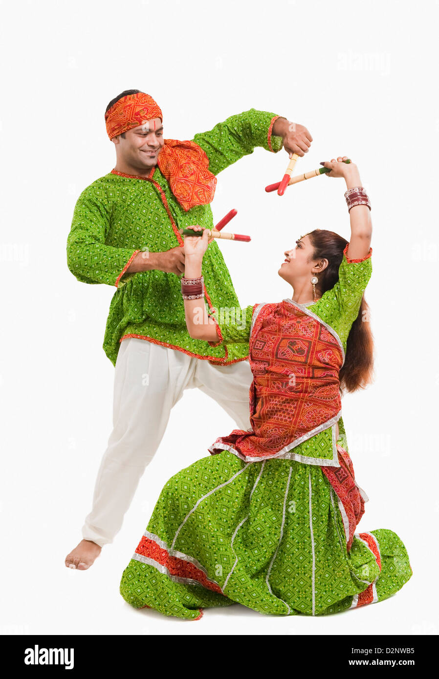 Couple performing dandiya Stock Photo - Alamy
