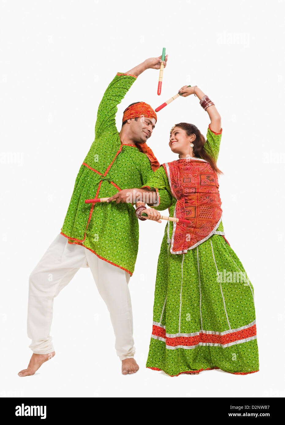 Couple performing dandiya Stock Photo - Alamy