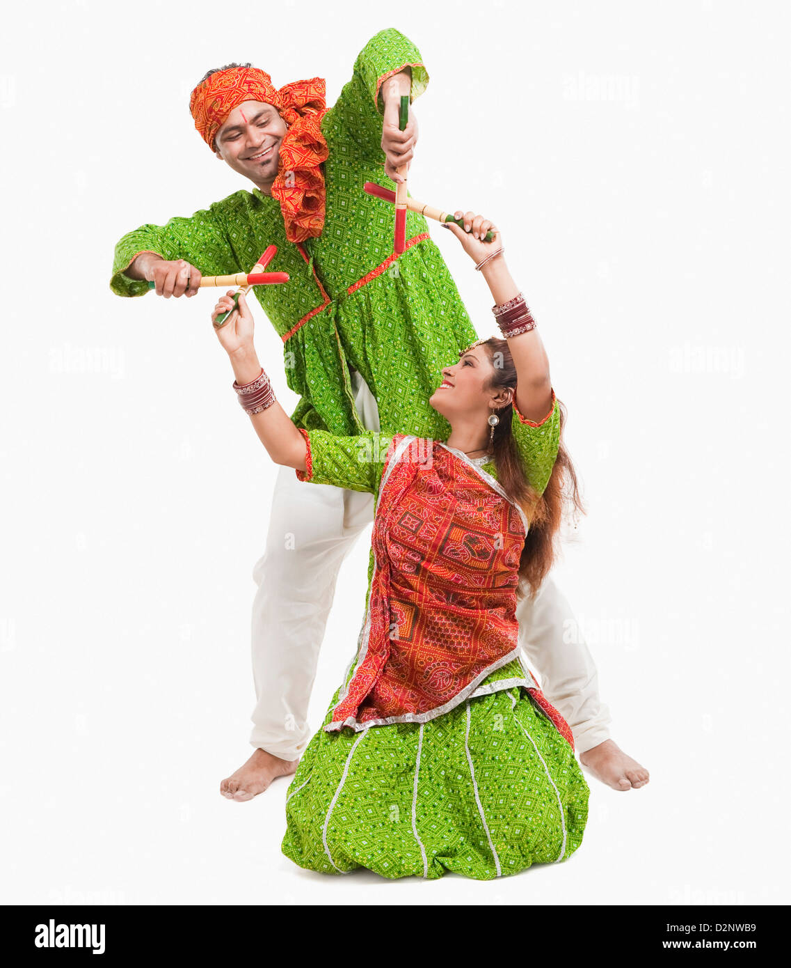 Couple performing dandiya Stock Photo - Alamy