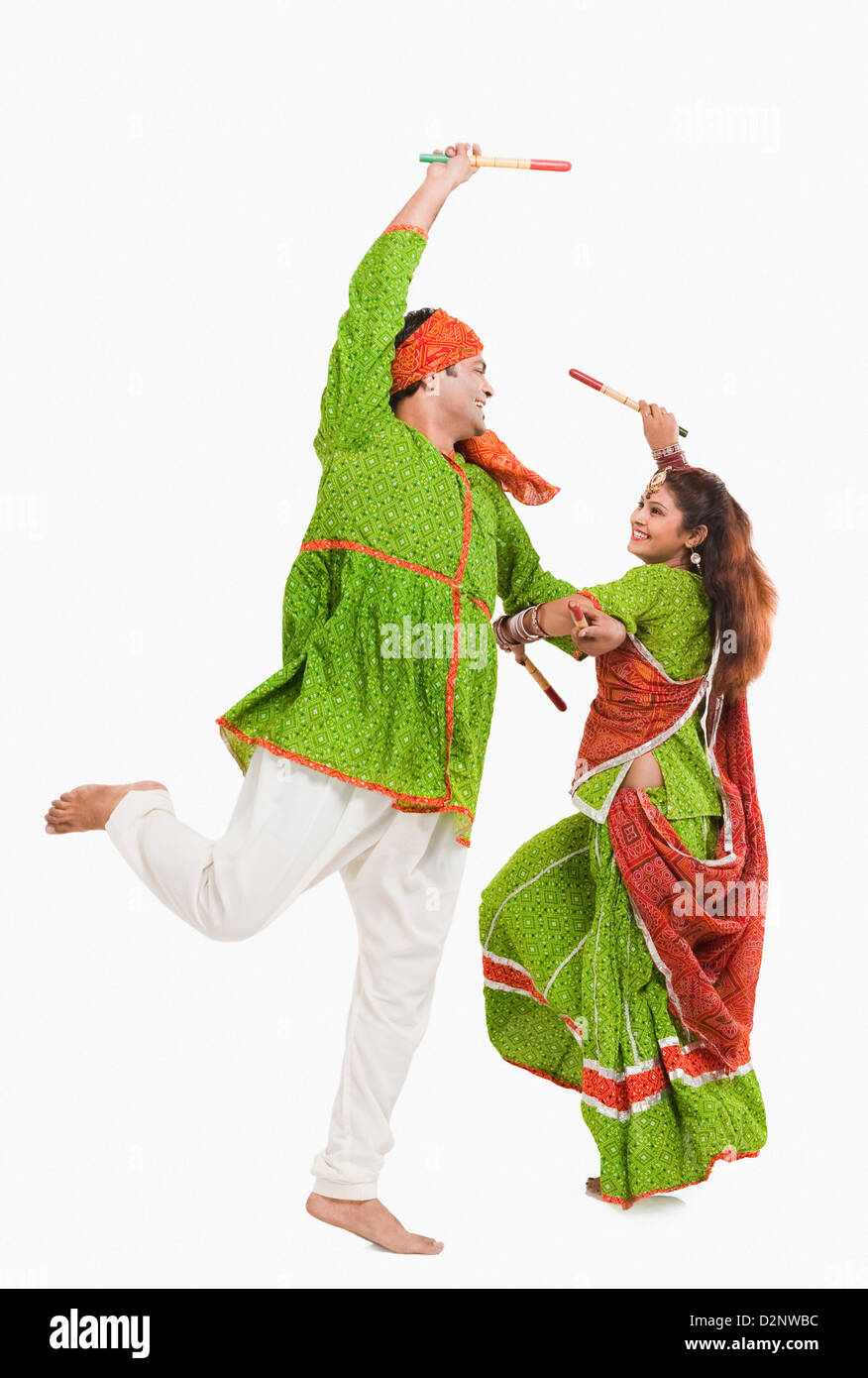 Couple performing dandiya Stock Photo - Alamy