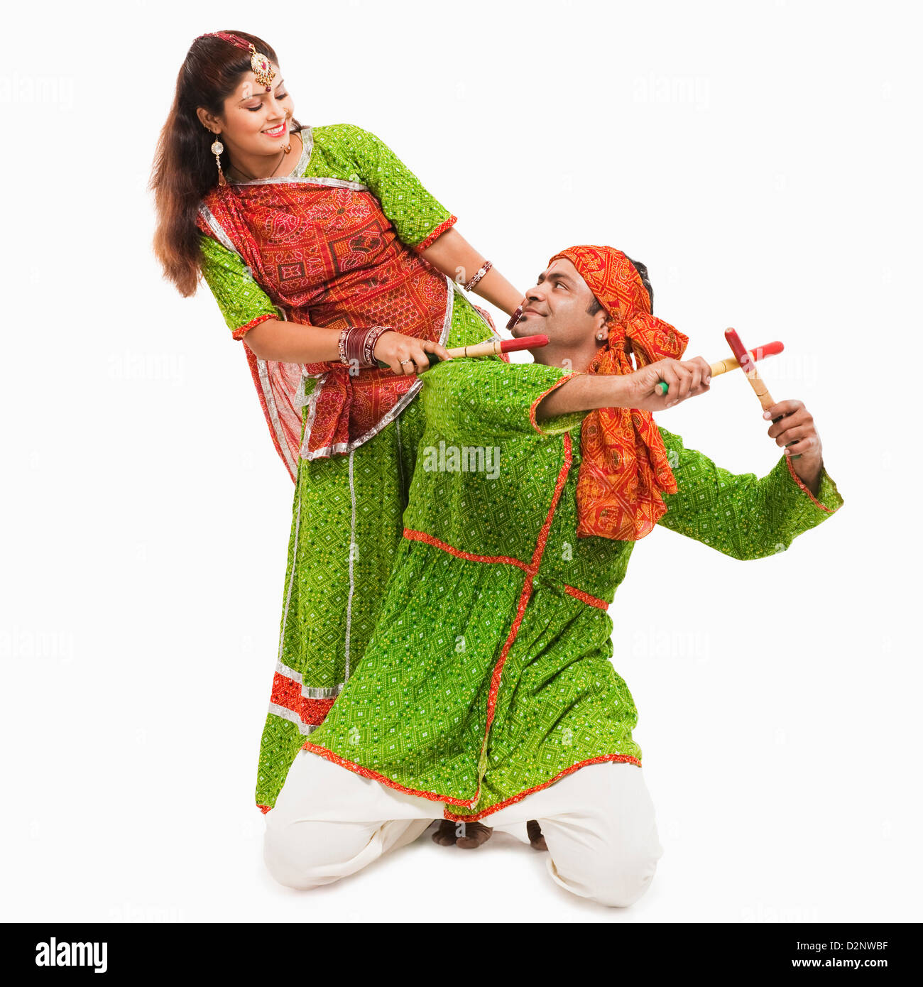 Couple performing dandiya Stock Photo - Alamy