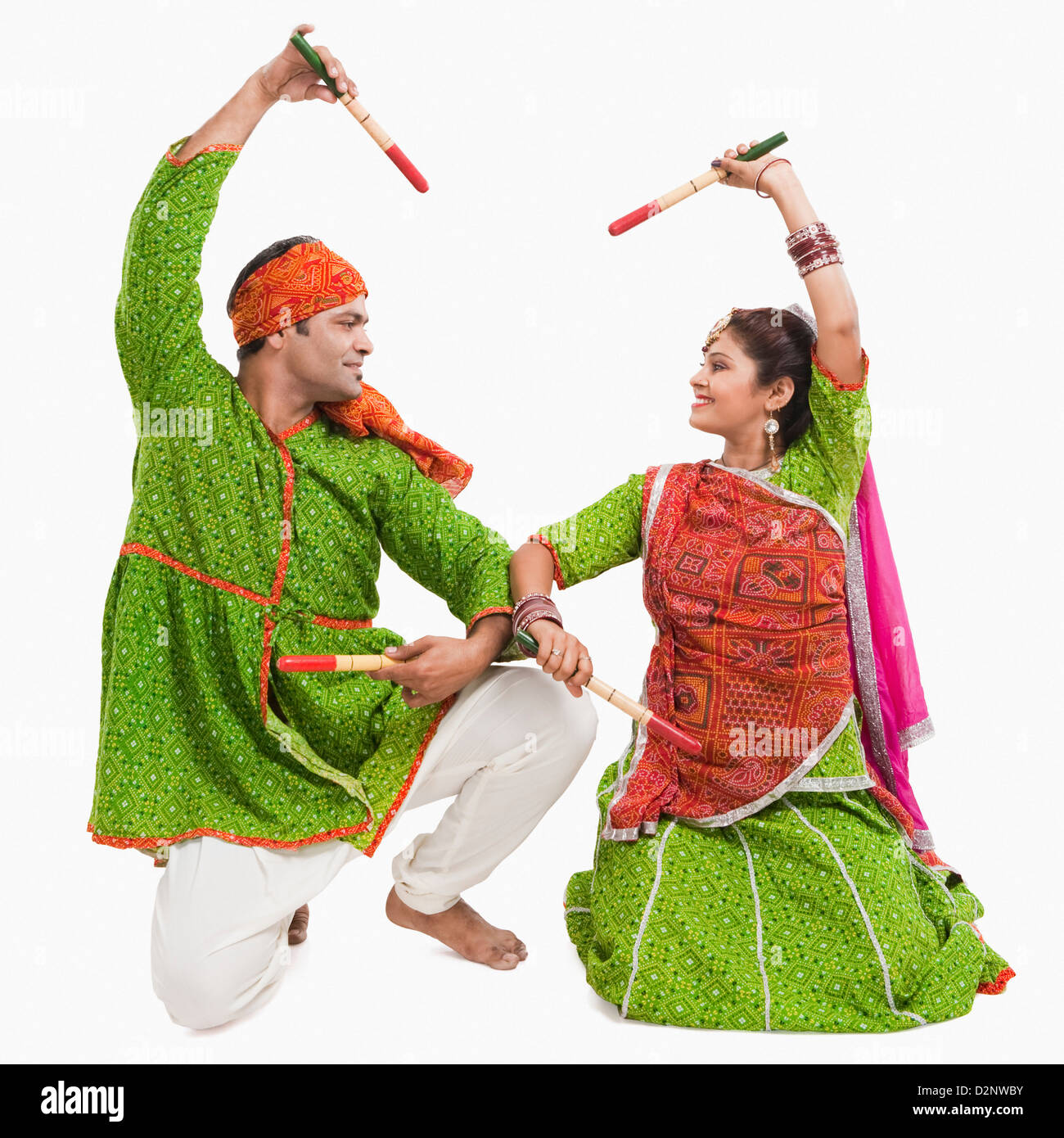 Couple performing dandiya Stock Photo - Alamy
