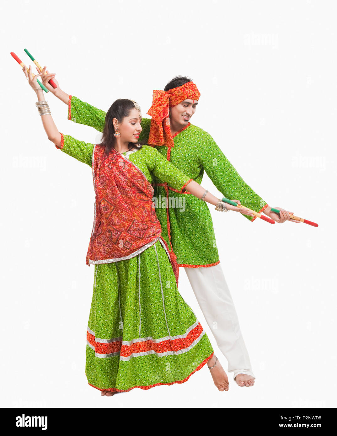 Couple performing dandiya Stock Photo - Alamy