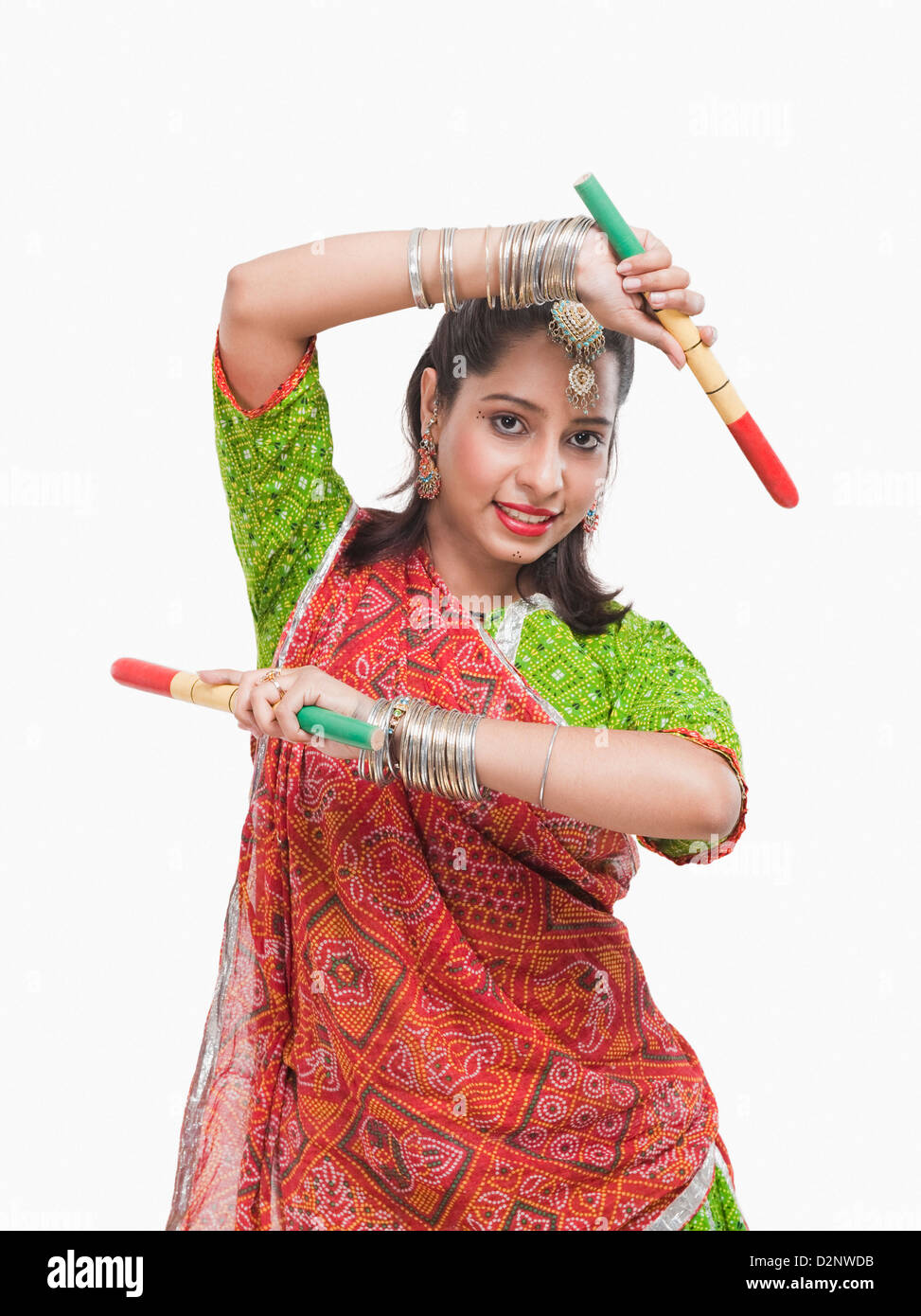 Portrait of a woman performing dandiya Stock Photo - Alamy