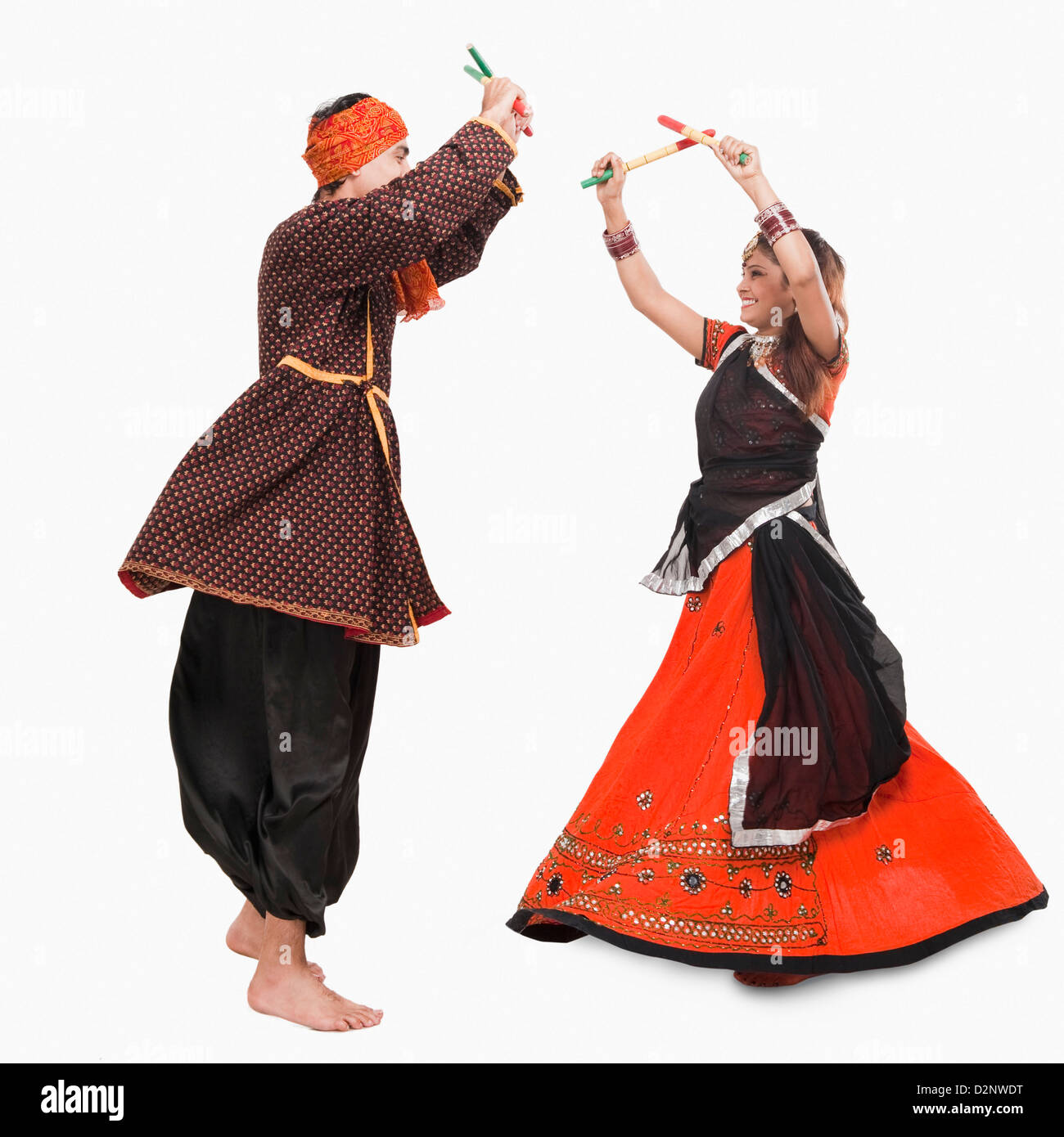 Couple performing dandiya Stock Photo - Alamy