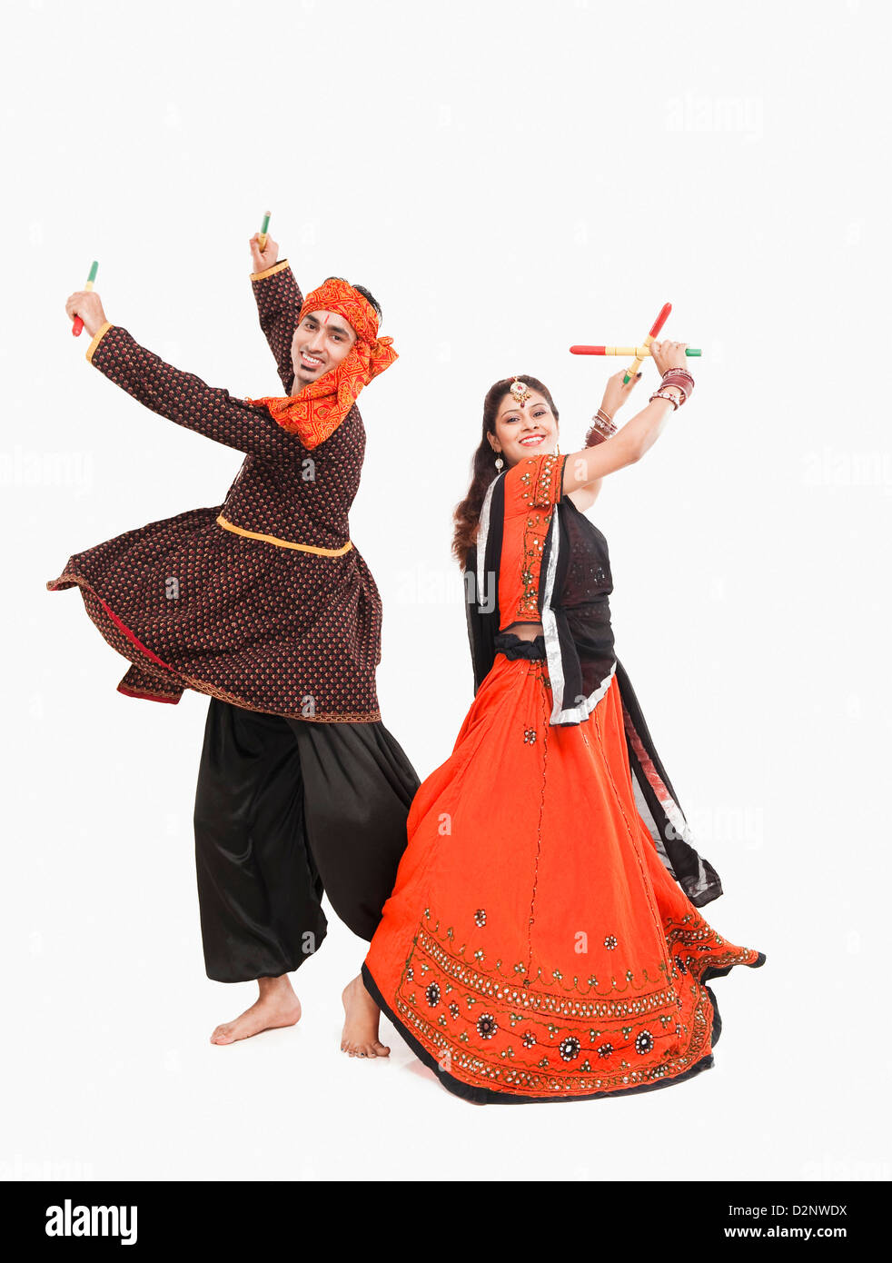 Couple performing dandiya Stock Photo - Alamy