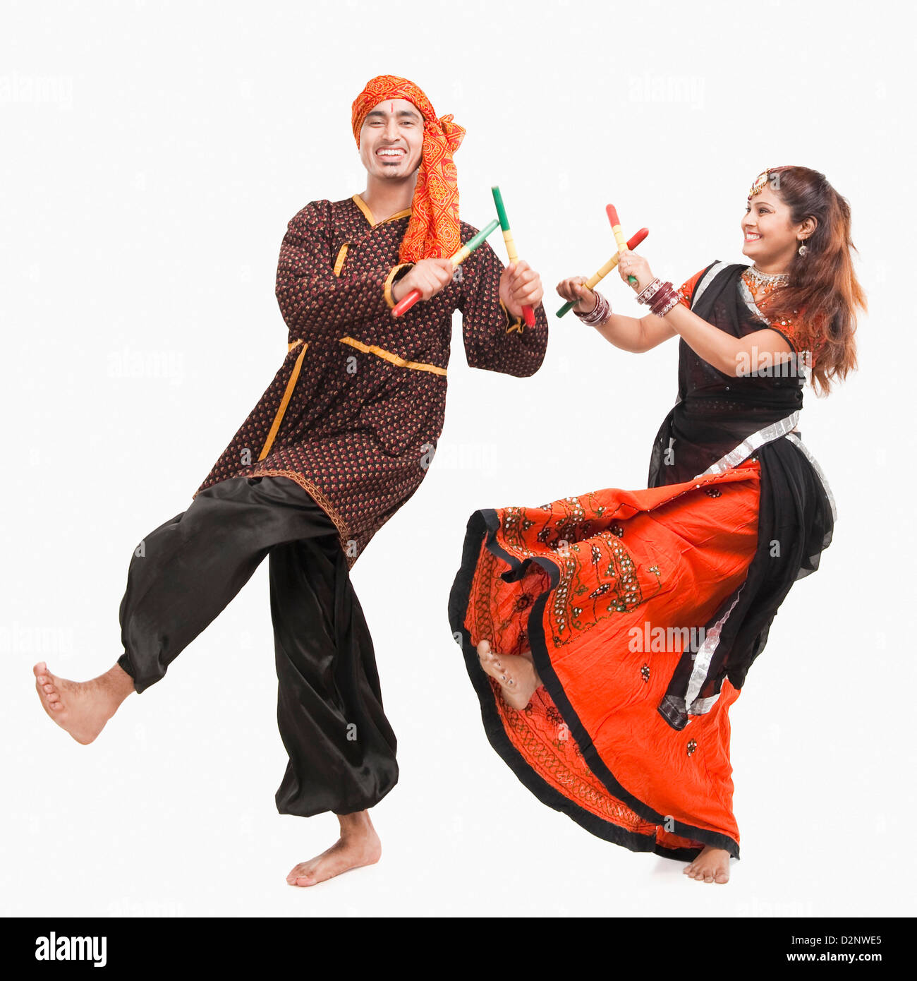 Couple performing dandiya Stock Photo - Alamy