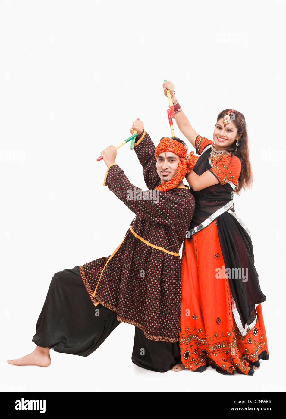 Couple performing dandiya Stock Photo - Alamy
