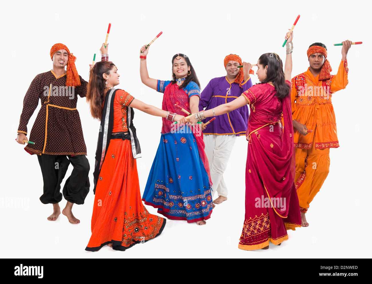 Men and women performing dandiya Stock Photo - Alamy
