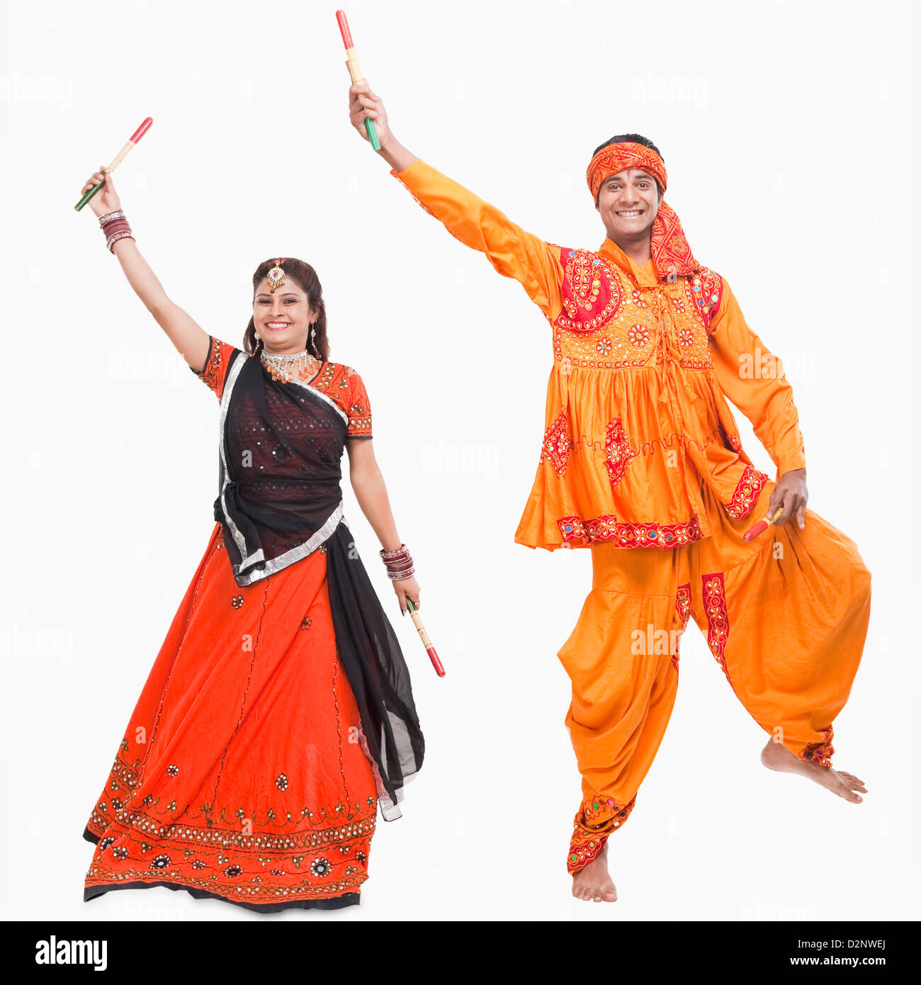 Couple performing dandiya Stock Photo - Alamy
