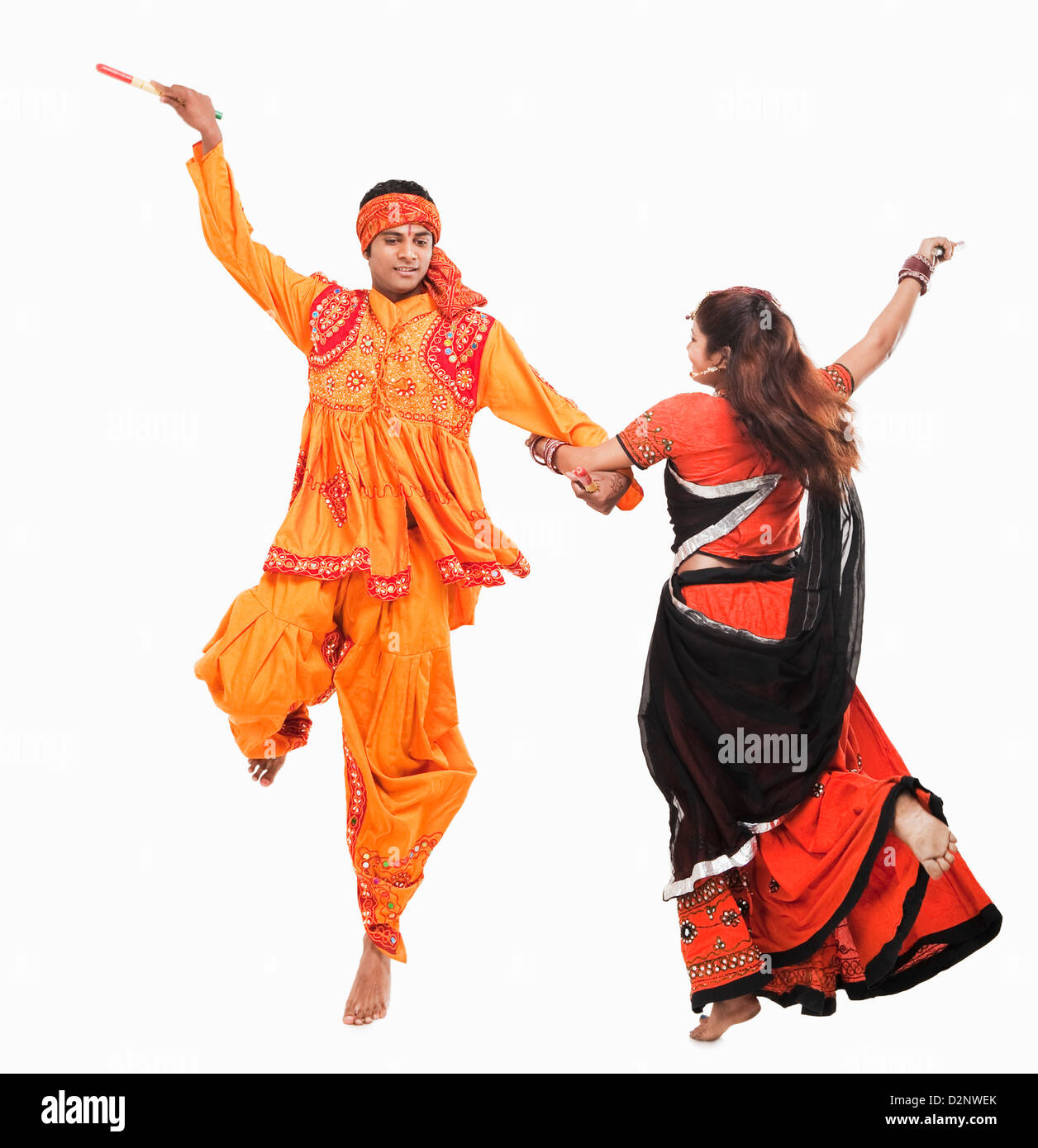 Couple performing dandiya Stock Photo - Alamy
