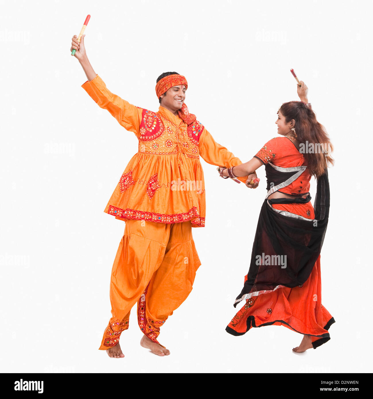 Couple performing dandiya Stock Photo - Alamy