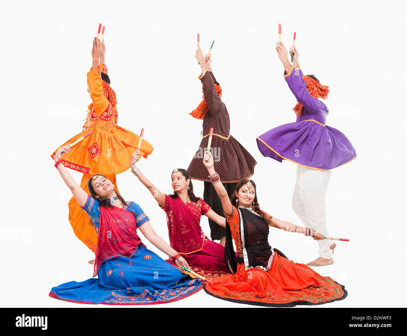 Men and women performing dandiya Stock Photo - Alamy
