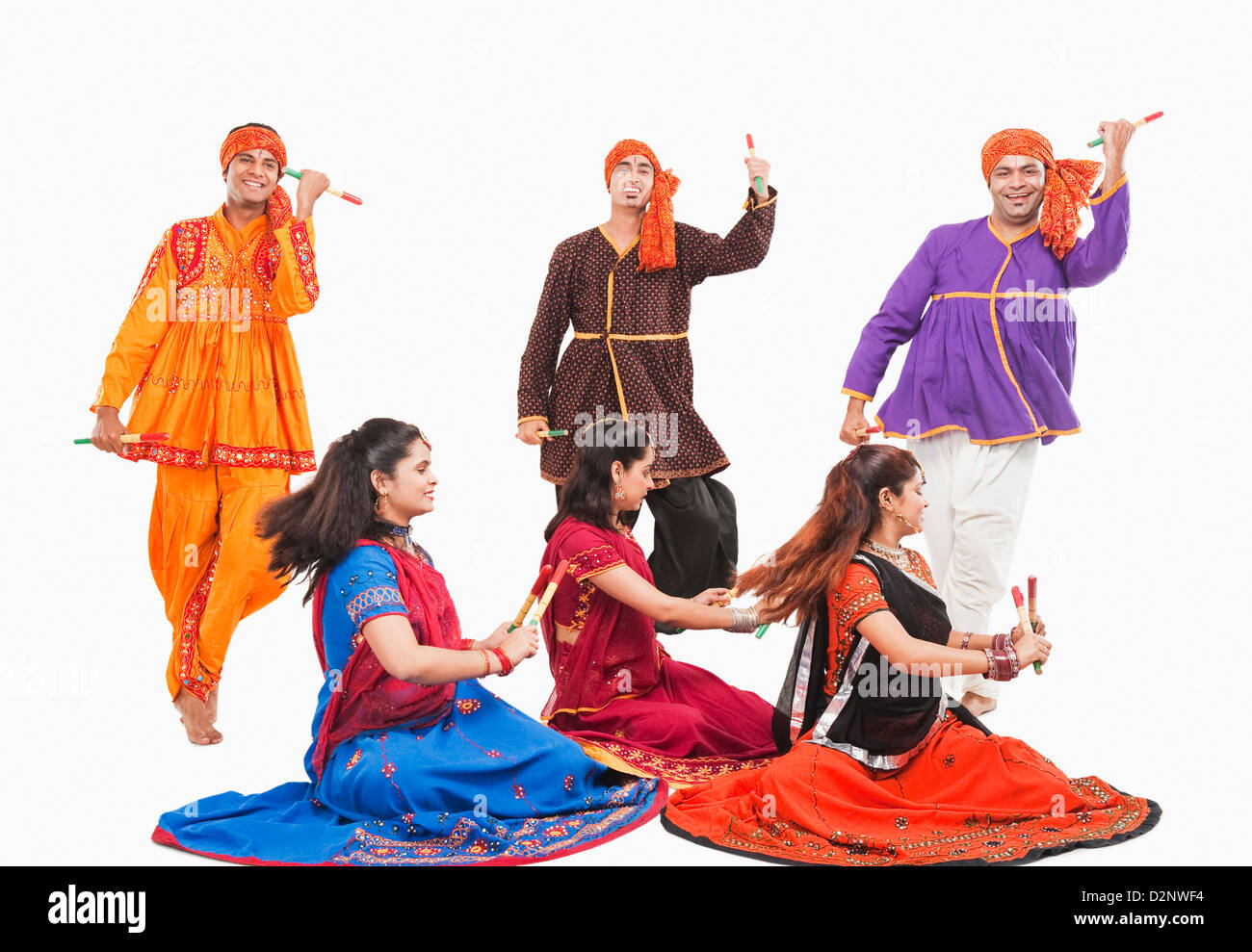 Men and women performing dandiya Stock Photo - Alamy