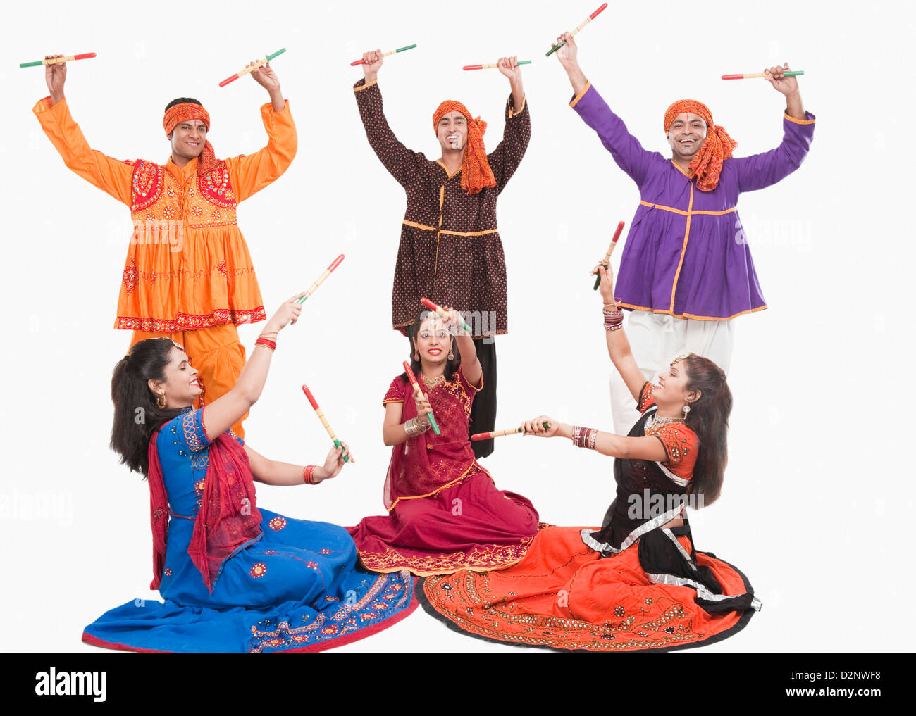 Men and women performing dandiya Stock Photo - Alamy