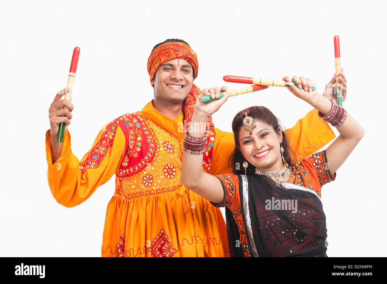 Couple performing dandiya Stock Photo - Alamy