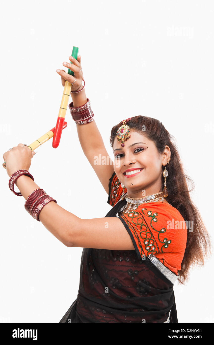 Portrait of a woman performing dandiya Stock Photo - Alamy