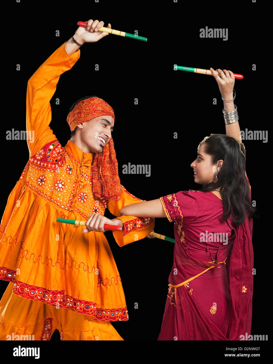 Couple performing dandiya Stock Photo - Alamy