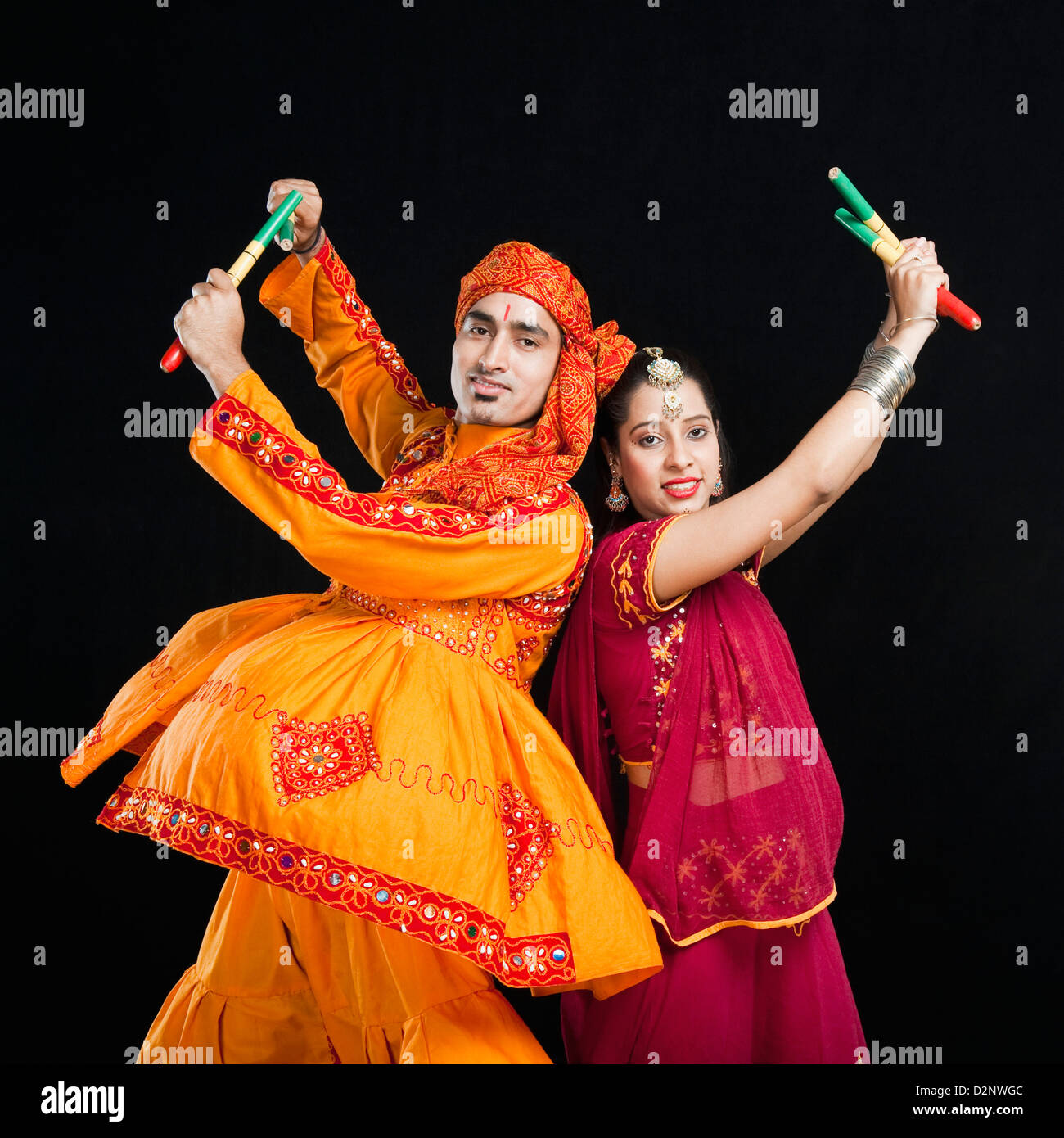 Couple performing dandiya Stock Photo - Alamy