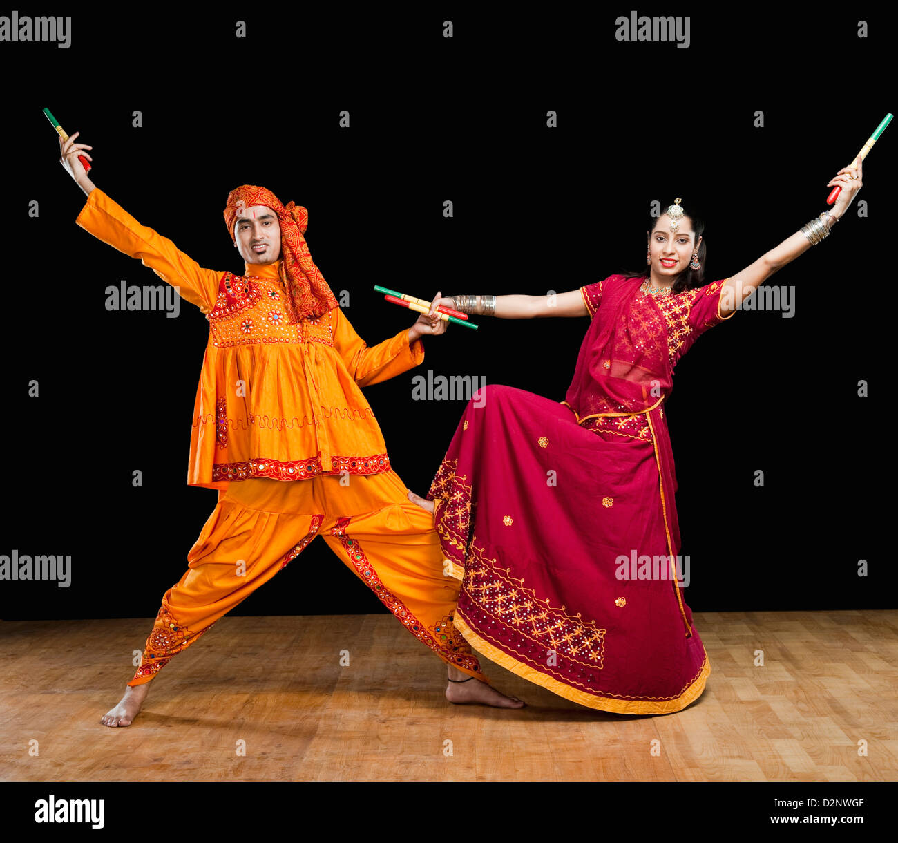 Couple performing dandiya Stock Photo