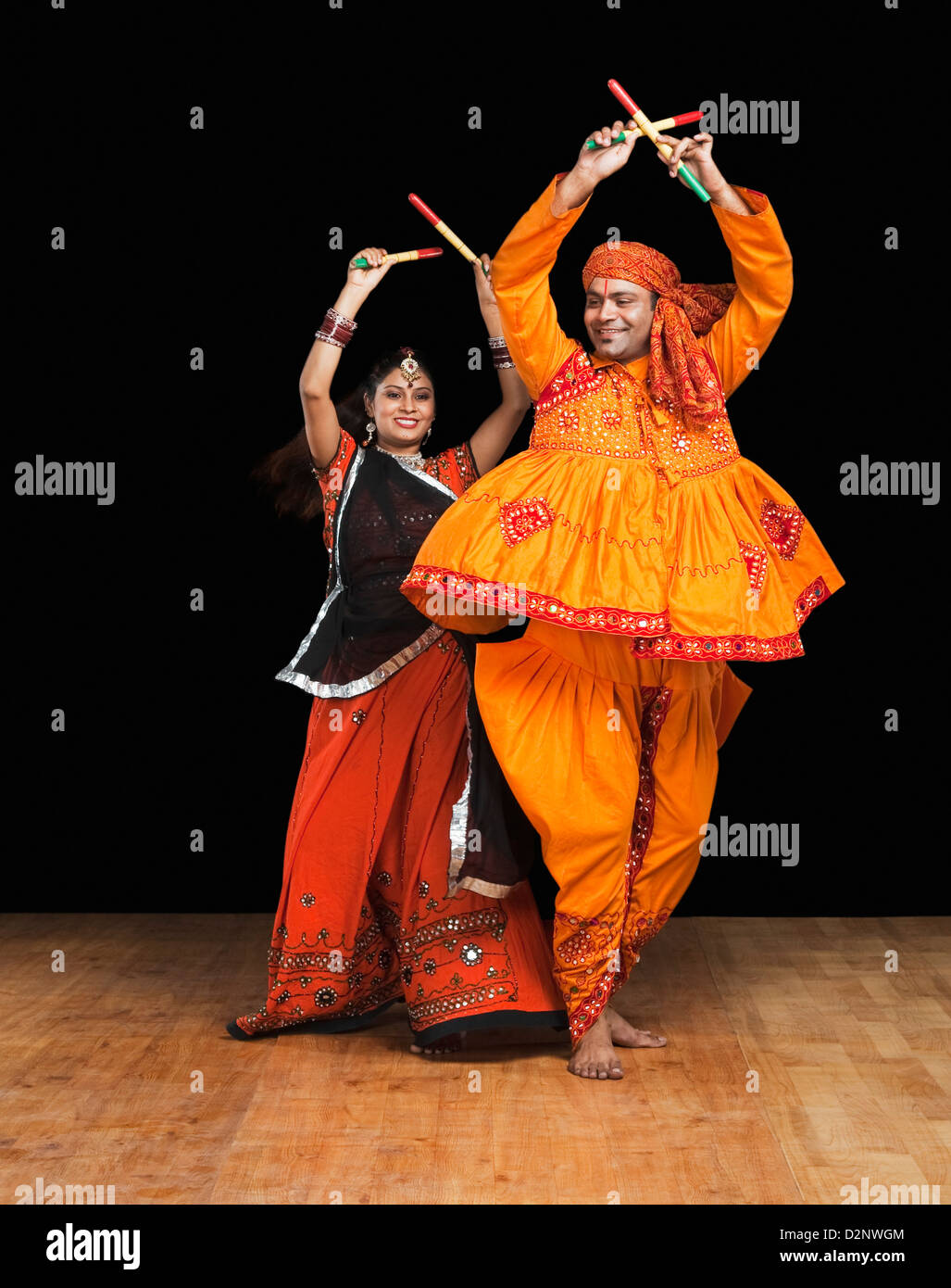 Couple performing dandiya Stock Photo - Alamy