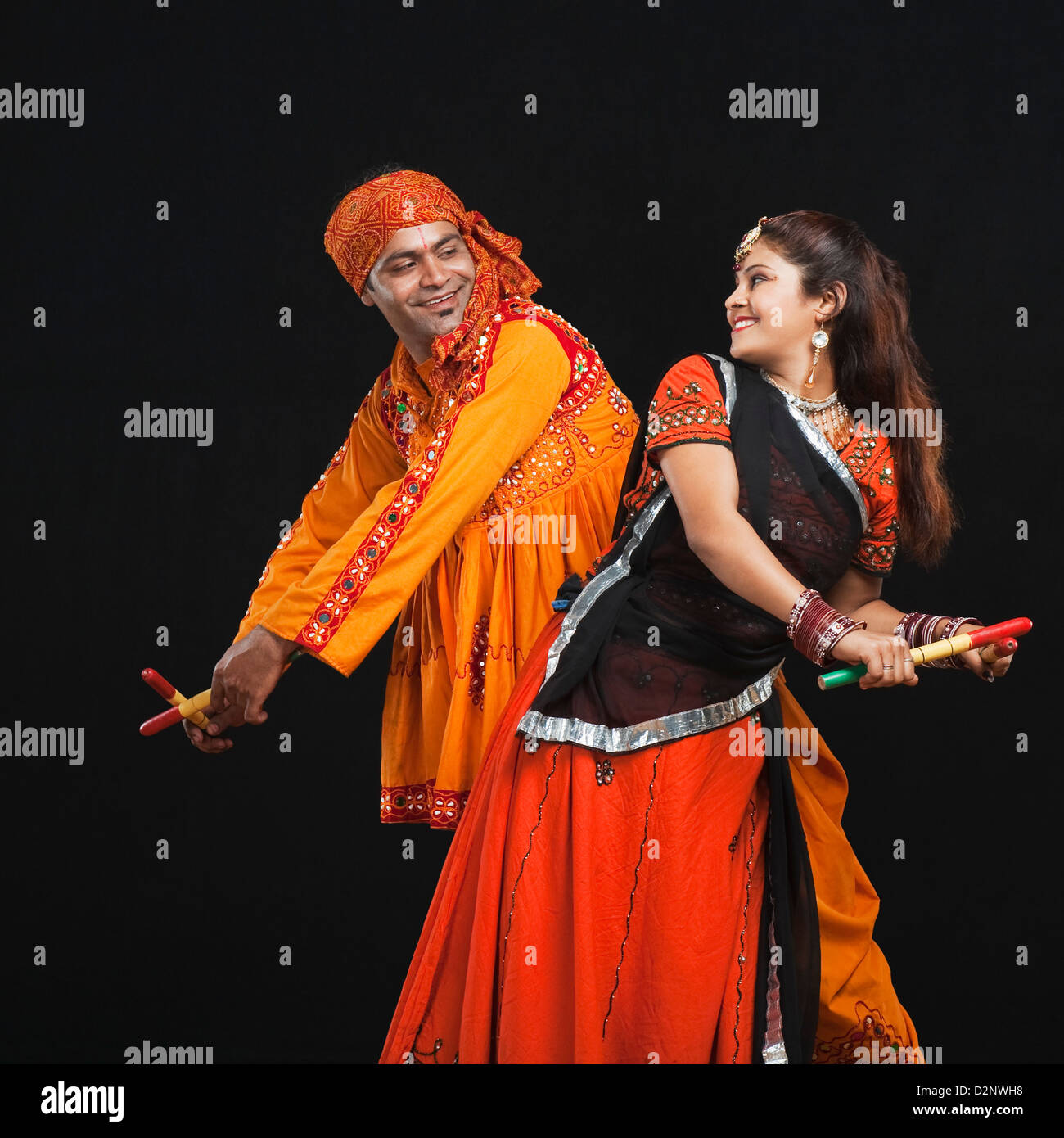 Couple performing dandiya Stock Photo - Alamy