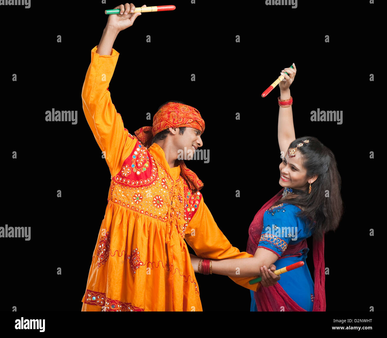 Couple performing dandiya Stock Photo - Alamy