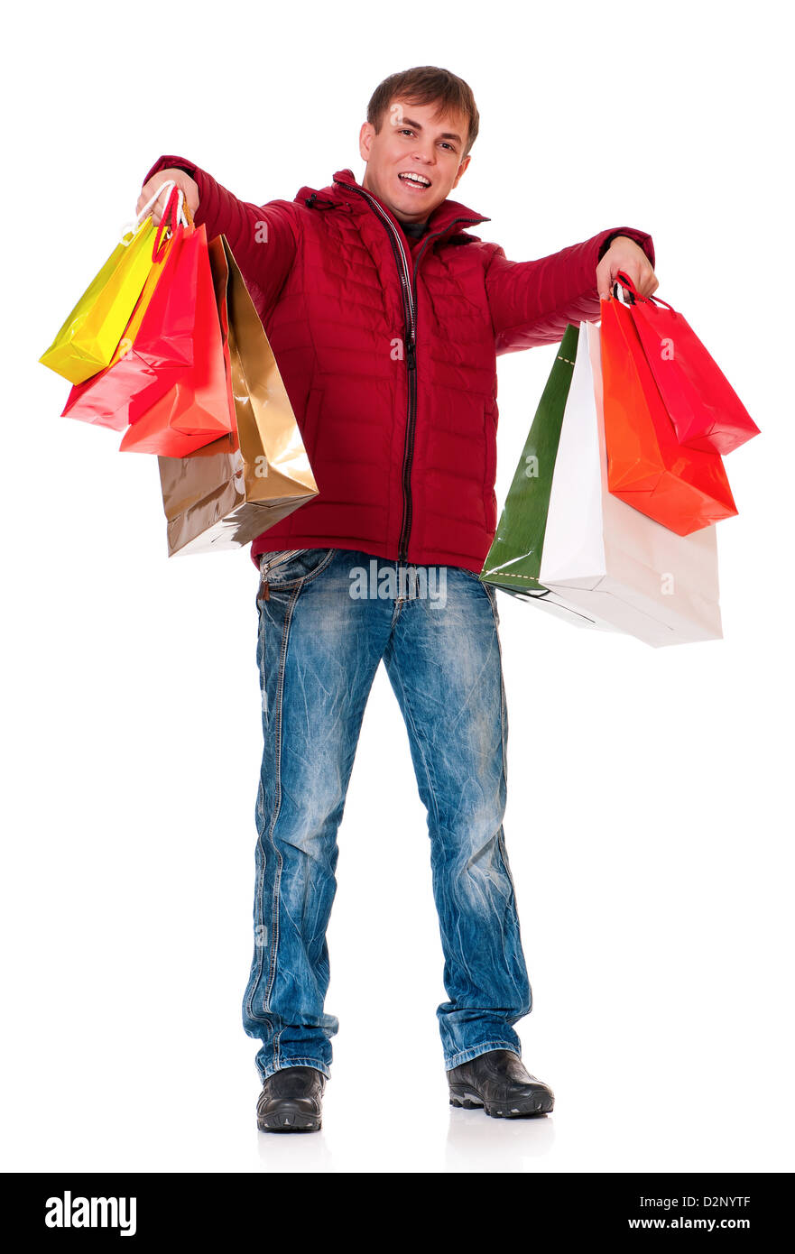 Full length portrait of a young man in winter clothing with shopping ...
