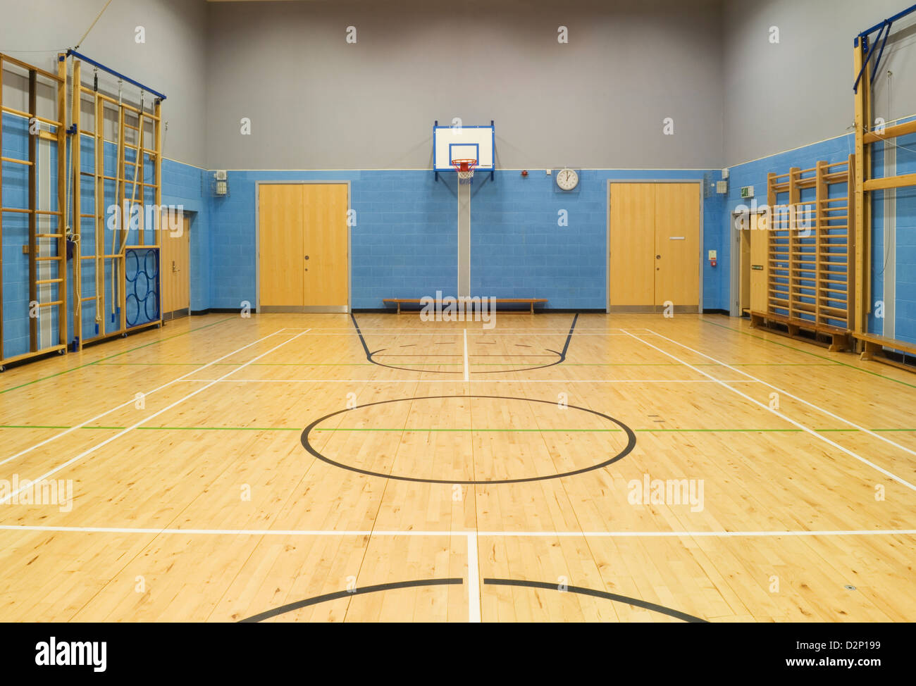 Gymnasium/sports hall in a modern secondary school, with basketball and  badminton courts marked out on the floor and equipment Stock Photo - Alamy