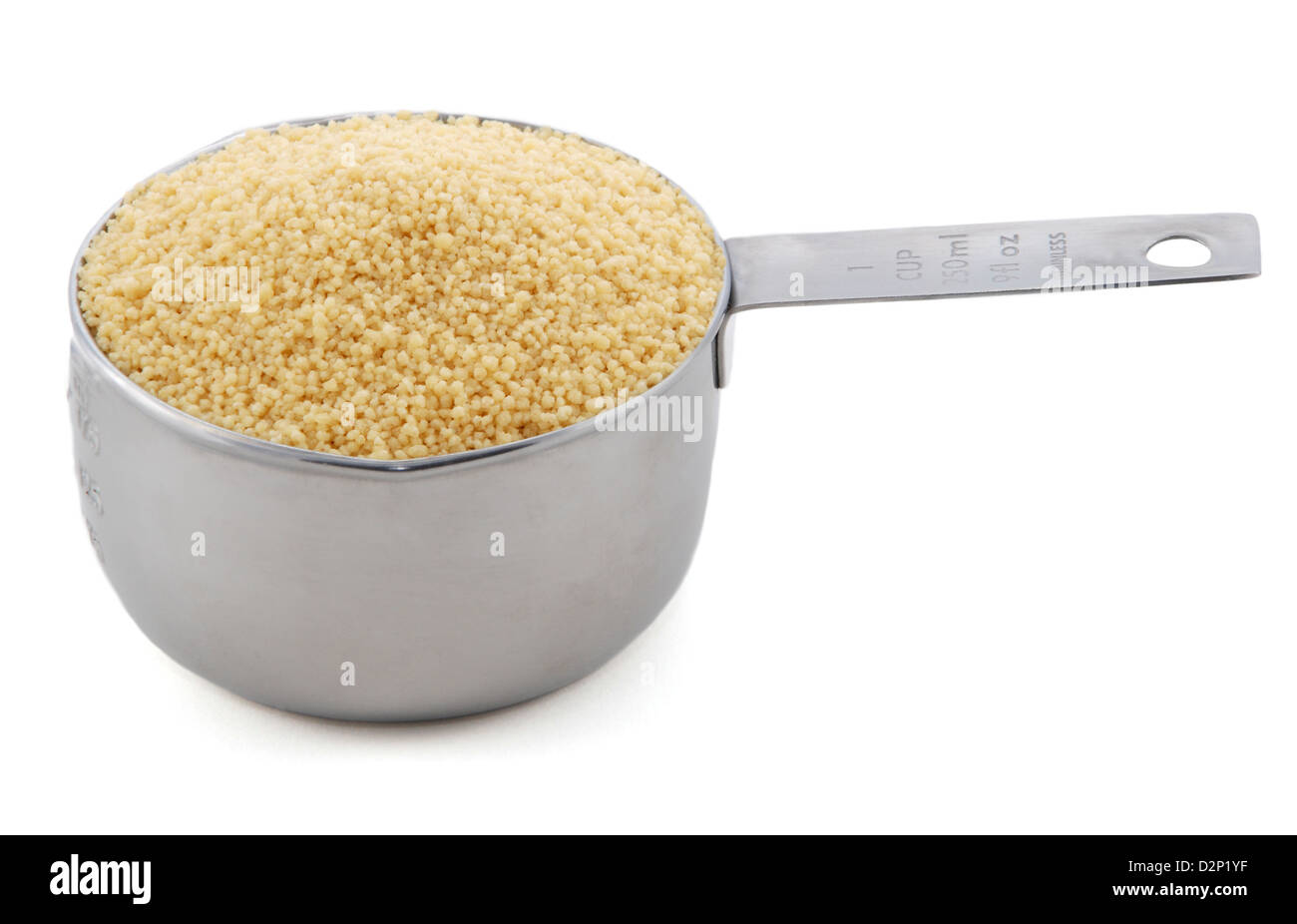 Cous cous presented in an American metal cup measure, isolated on a white background Stock Photo