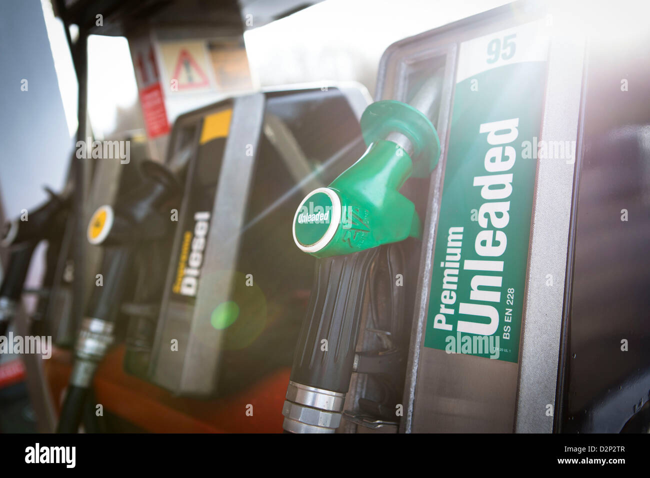 A close up view of a unleaded petrol pump with sun flare. Stock Photo